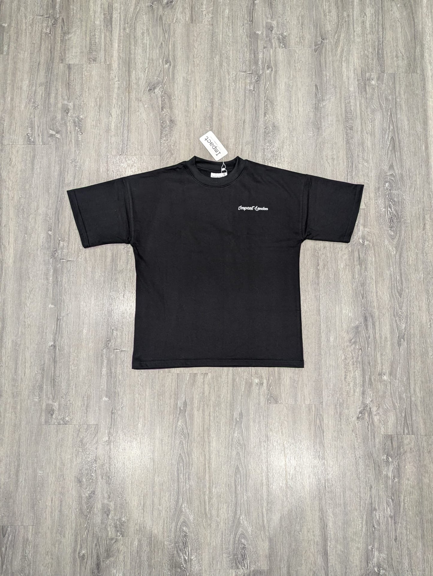 Unisex Oversized Black T-Shirt front view on the floor