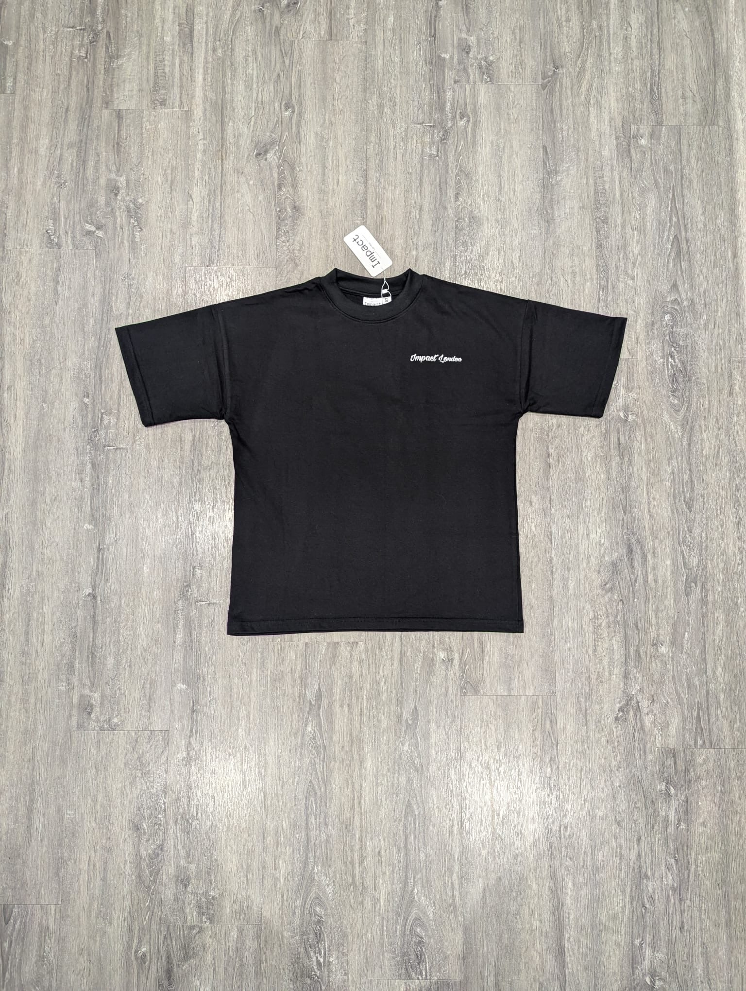 Unisex Oversized Black T-Shirt front view on the floor