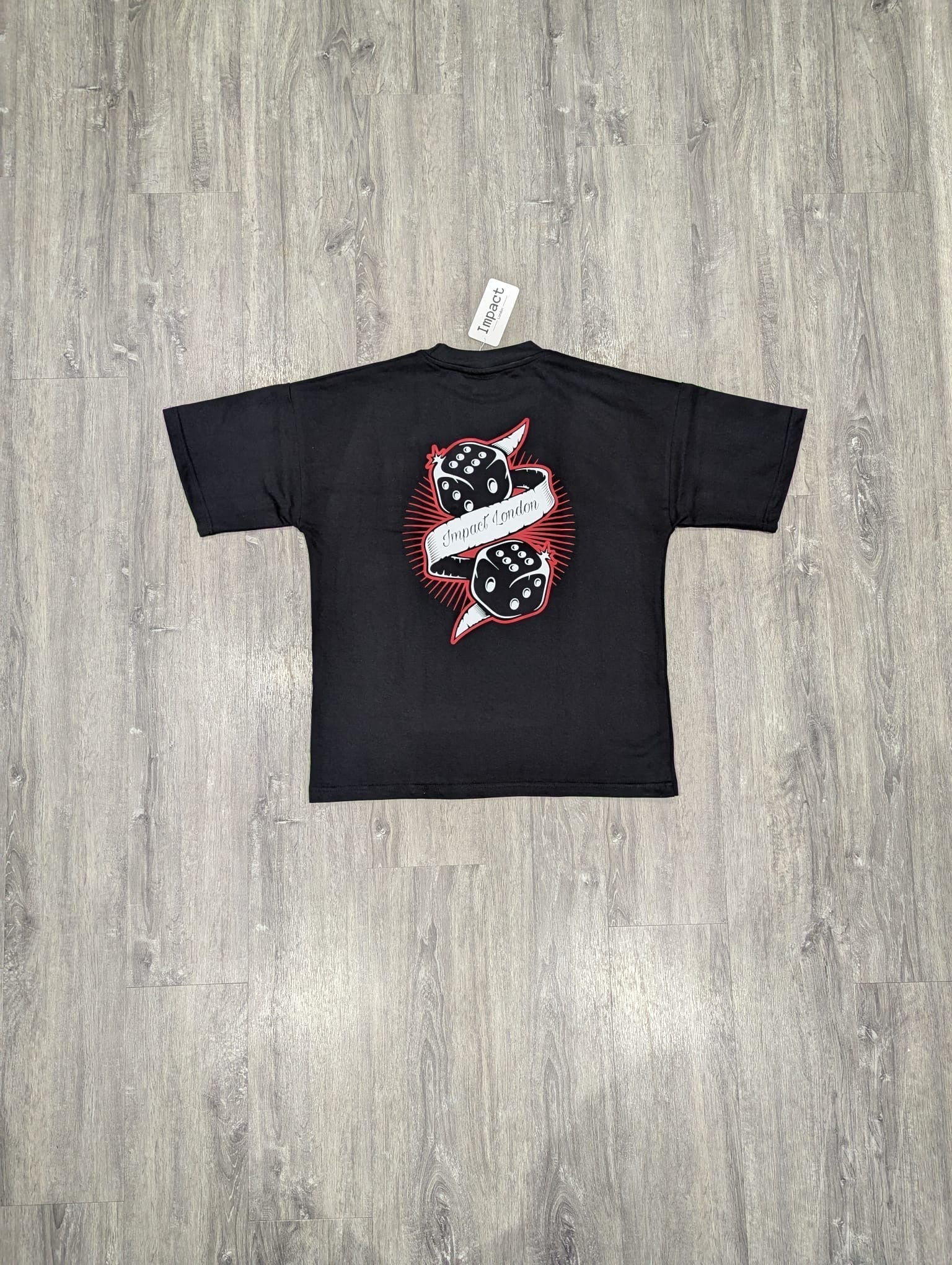 Unisex Oversized Black T-Shirt back view on the floor