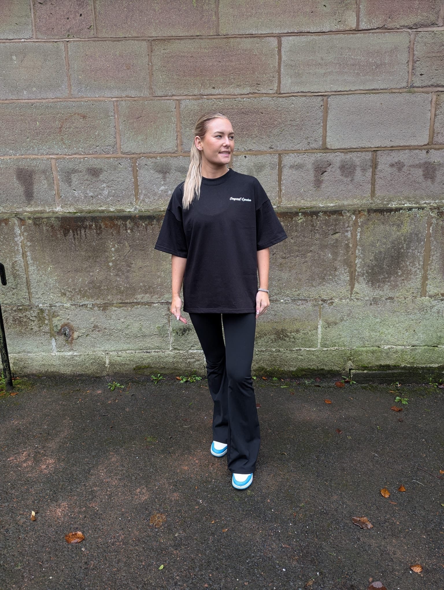 Female model wearing unisex overside black t-shirt