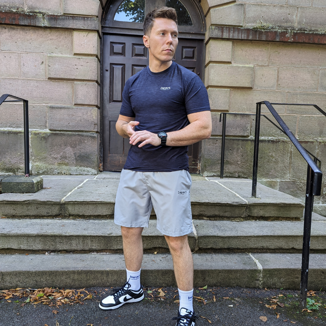 Actor and model Luke Charnley wearing the new navy performance t-shirt with grey light fit shorts 
