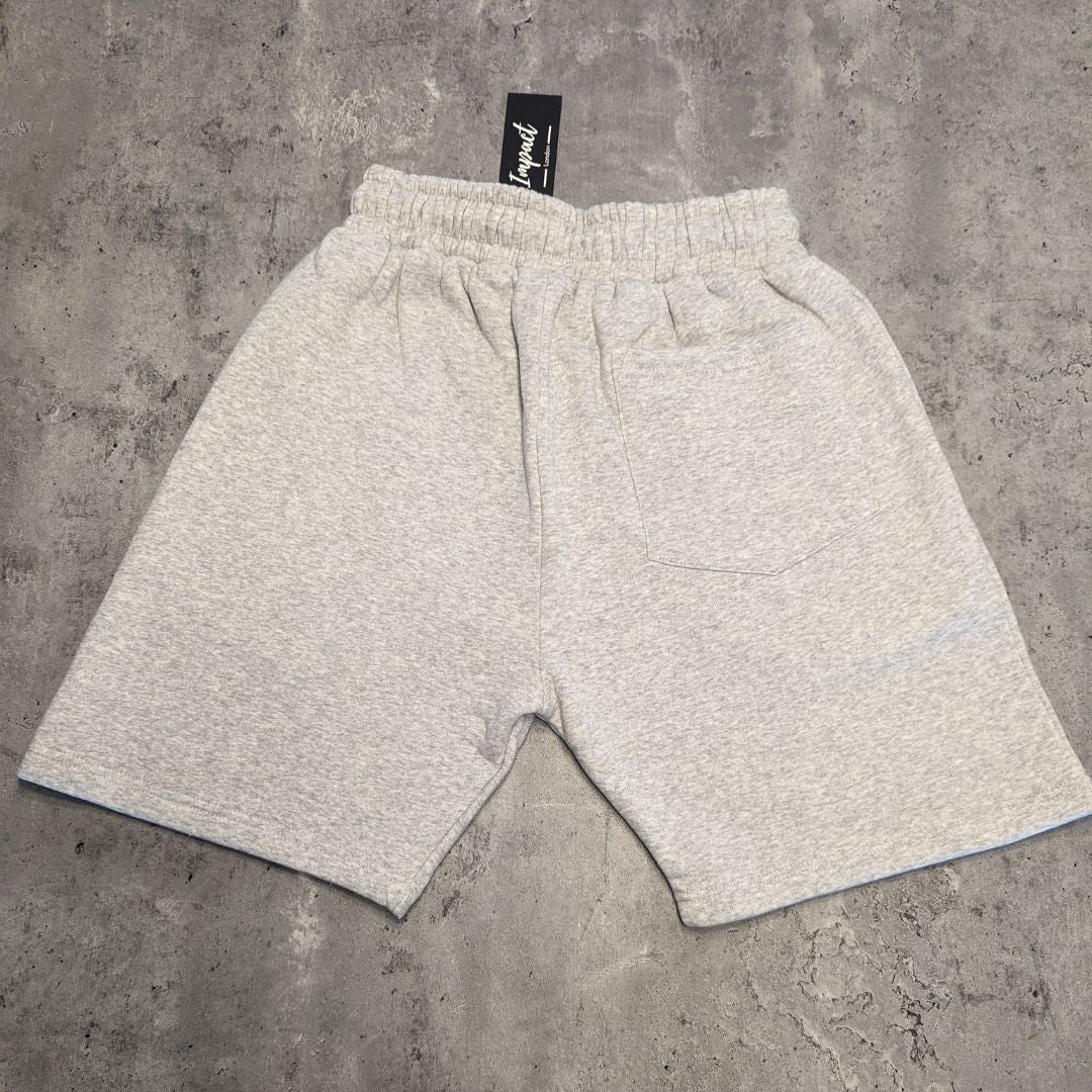 The back of the grey Impact London men's jogger shorts laid on a light grey wooden flooring