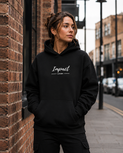 Female model wearing Impact London black hoodie with white embroidered logo