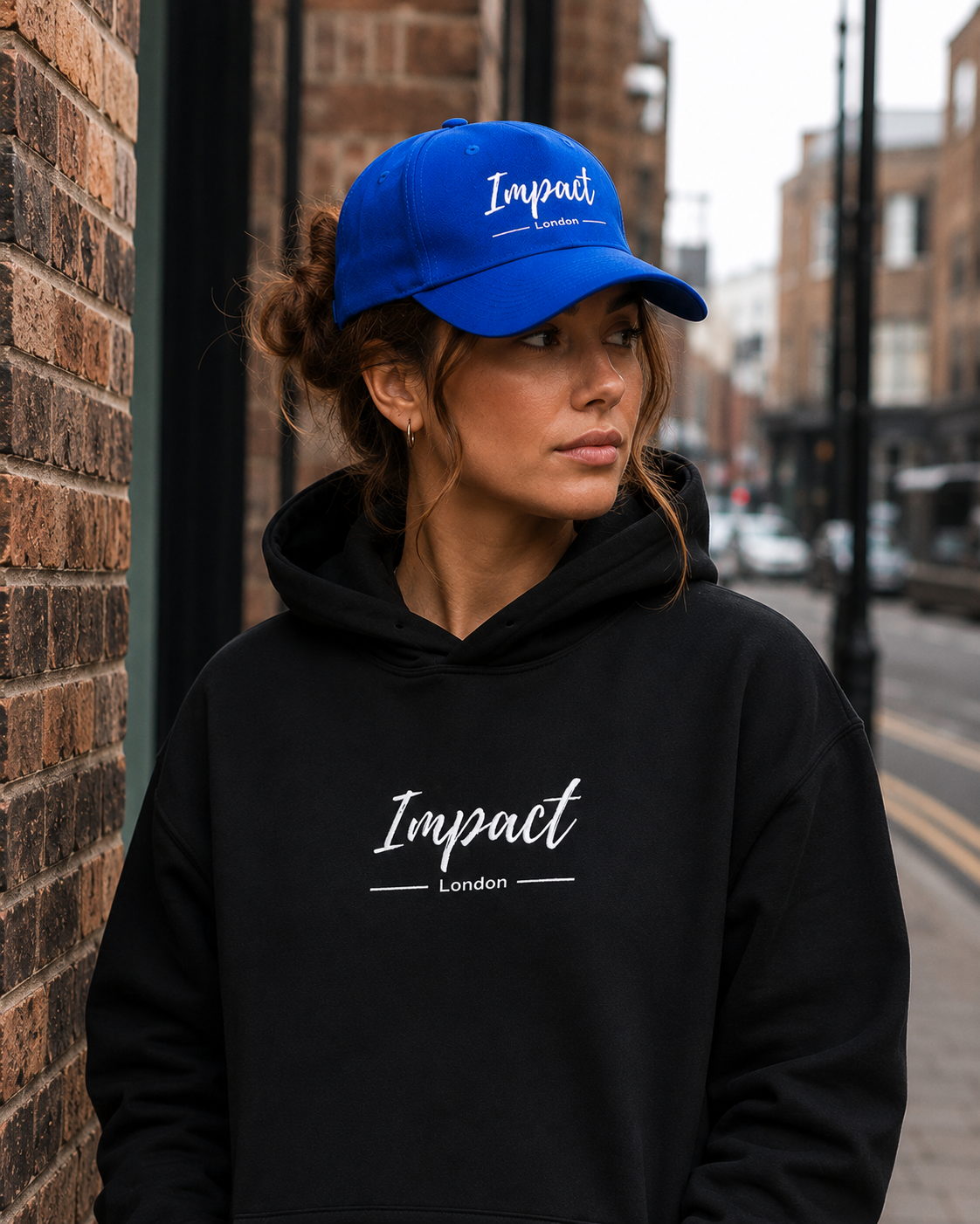 Female model wearing Impact Signature Royal Blue Cap by Impact London in an urban London setting
