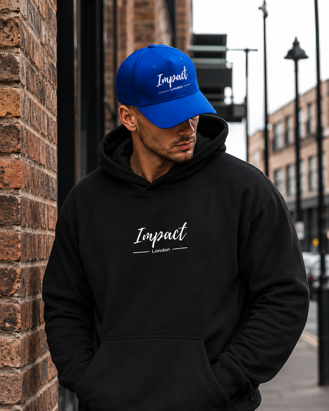 Male model wearing Impact Signature Royal Blue Cap by Impact London in an urban London setting