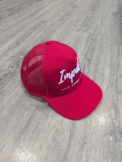 Red trucker cap with white logo from Impact London